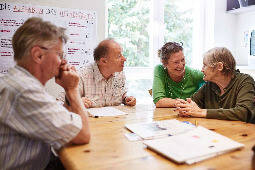 Zwei Männer und zwei Frauen, die an einem Tisch sitzen